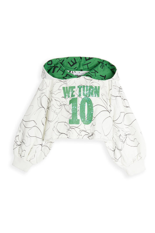 White sweatshirt with green text and patterns, featuring the text 'WE TURN' and the number '10' on the front.